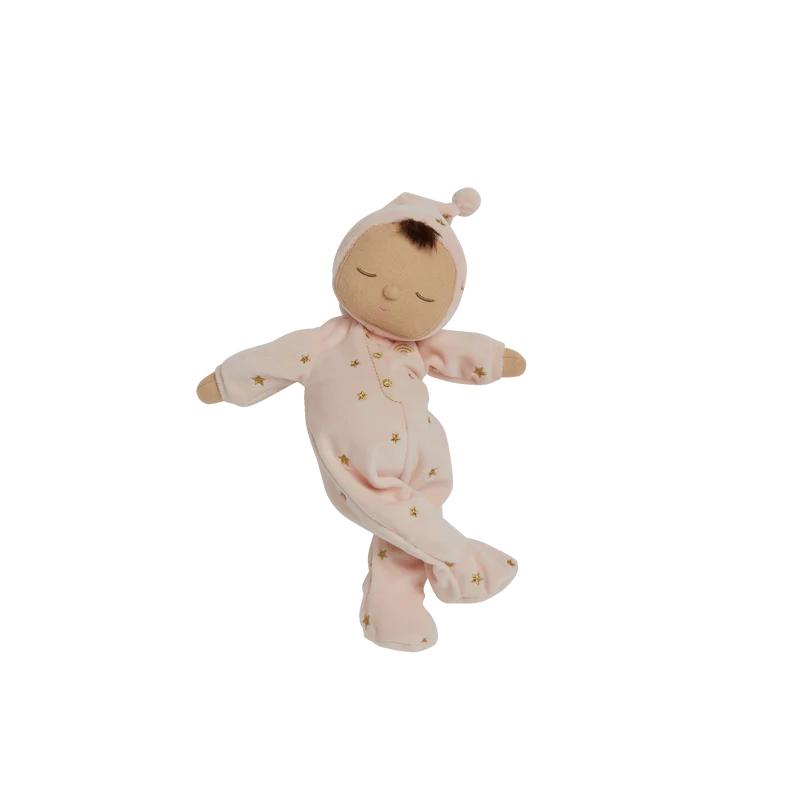 Baby in pink outfit holding a soft toy 